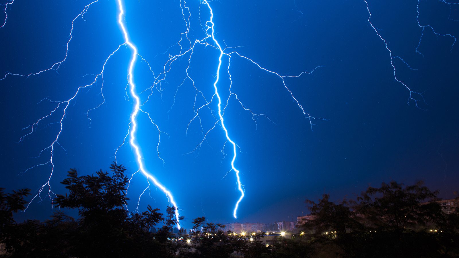 A picture of a lightning bolt at night.