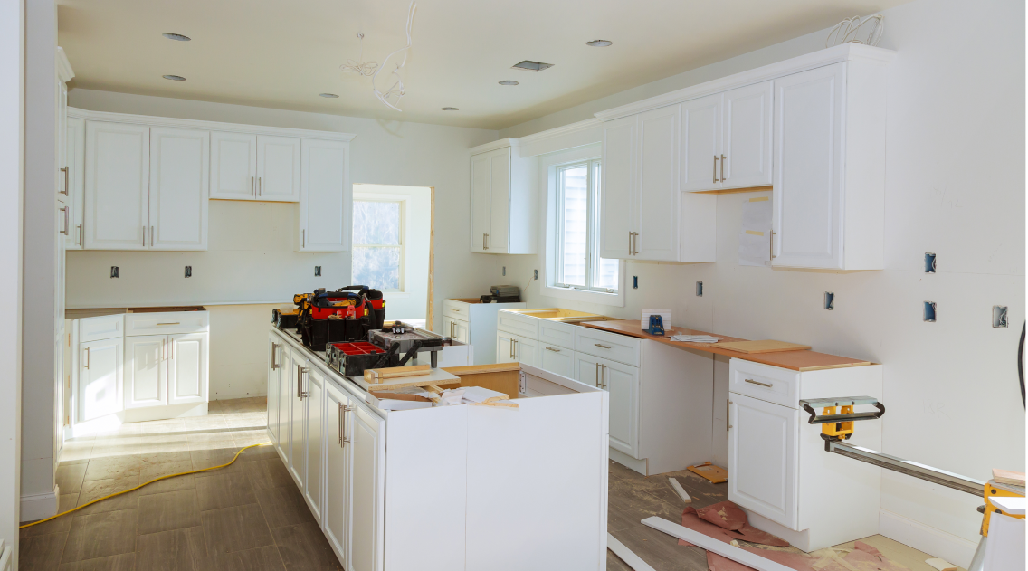 Kitchen with white cabinetry in the process of being renovated