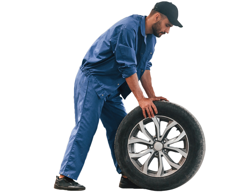 Auto repair man moving a tire.