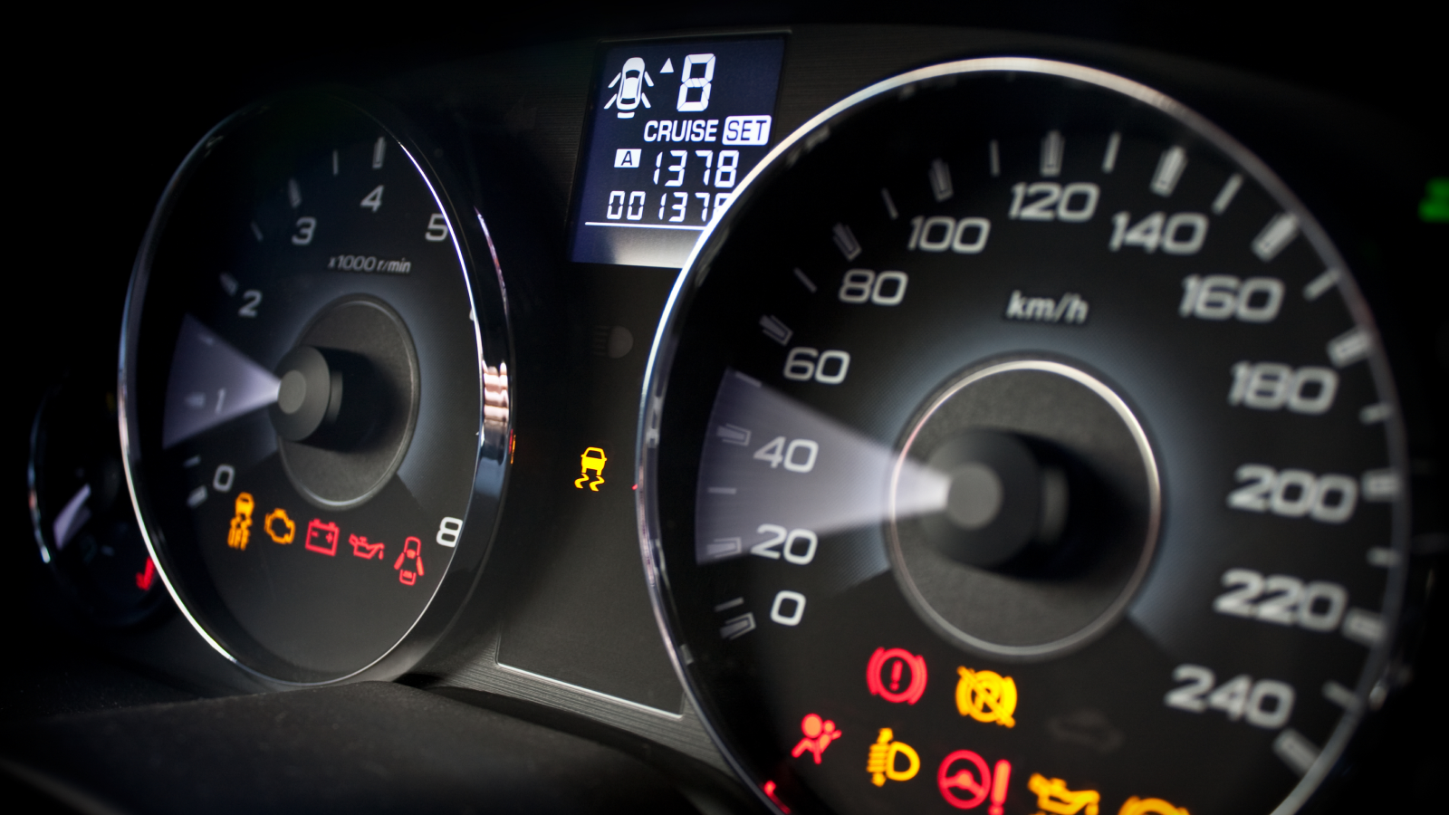 A picture of a car dashboard full of warning signals.