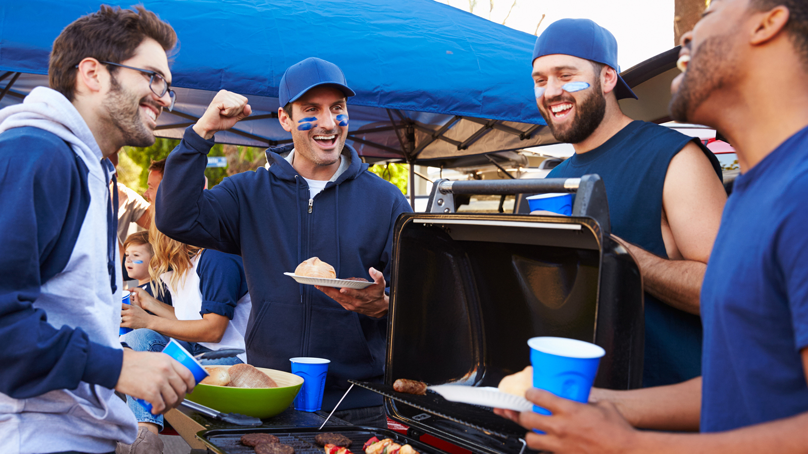 A picture of a group having fun at a tailgate.