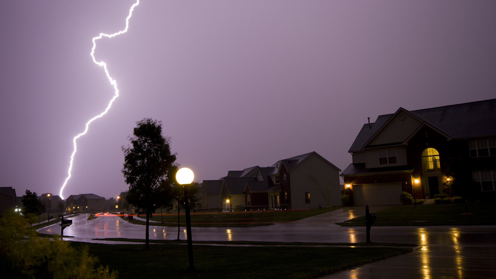 Lightning strike in neighborhood at night.