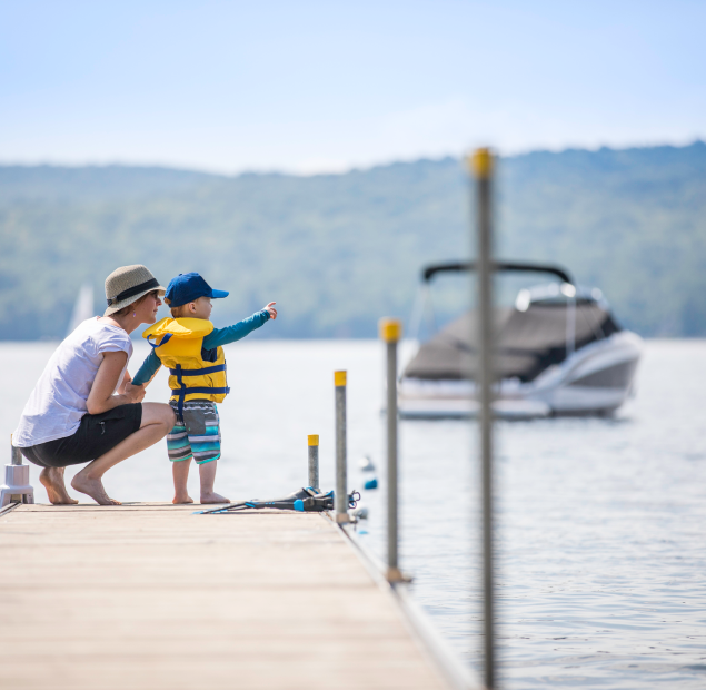 mom and kid on boat dock icon