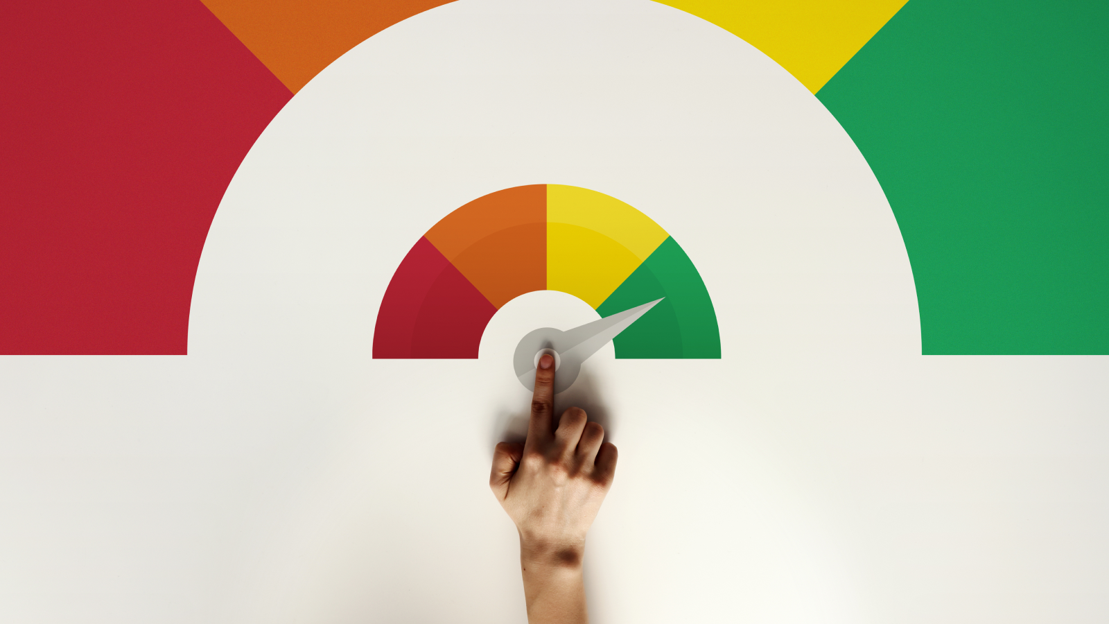 A finger pointing to the green section of a credit score-style meter colored red, yellow, and green, representing a high or favorable insurance score.