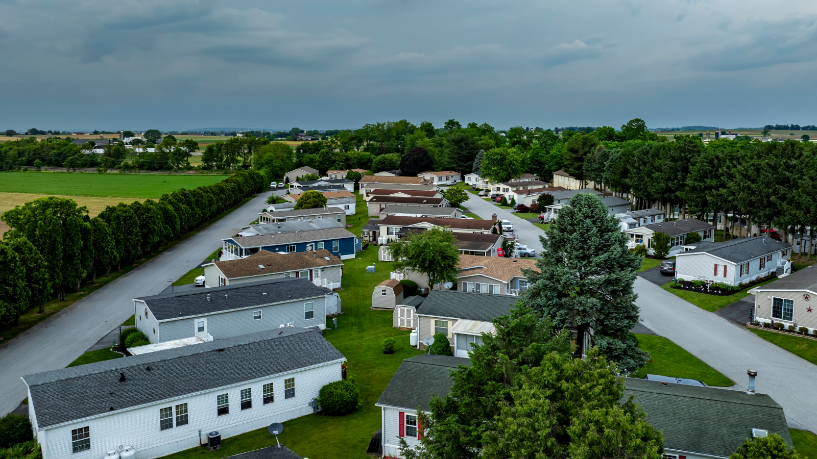 View of a mobile home community with cloudy, dark skies.