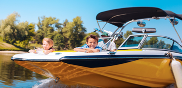 A family sitting in a boat on the water.