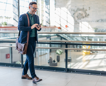 Man looking at phone while walking.