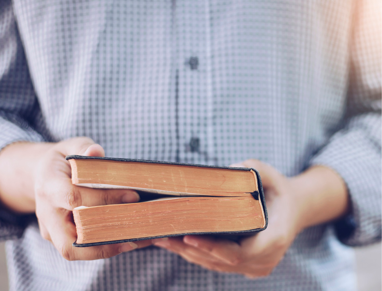 Man holding the bible.