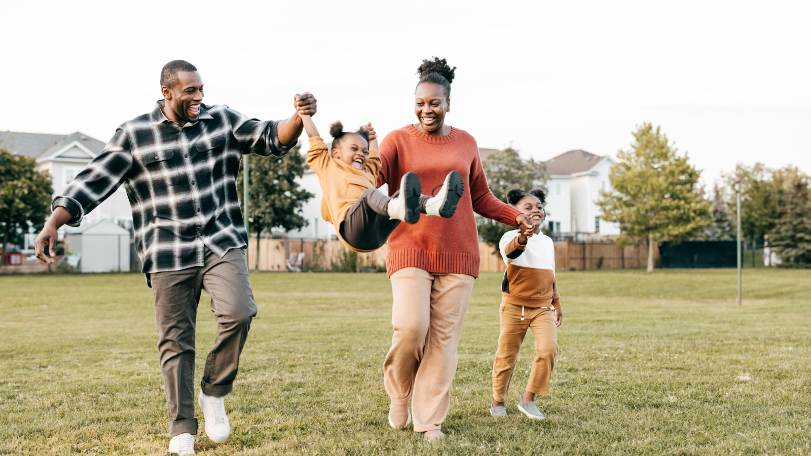 Family walking and playing with children outside. 