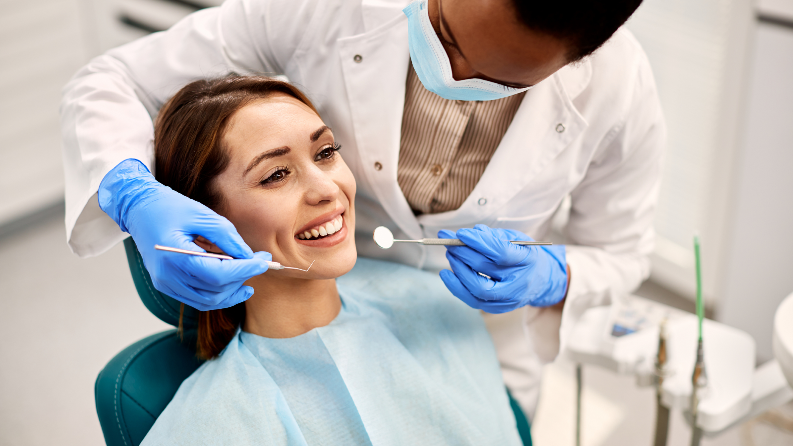 A picture of a girl at the dentist getting dental work done.