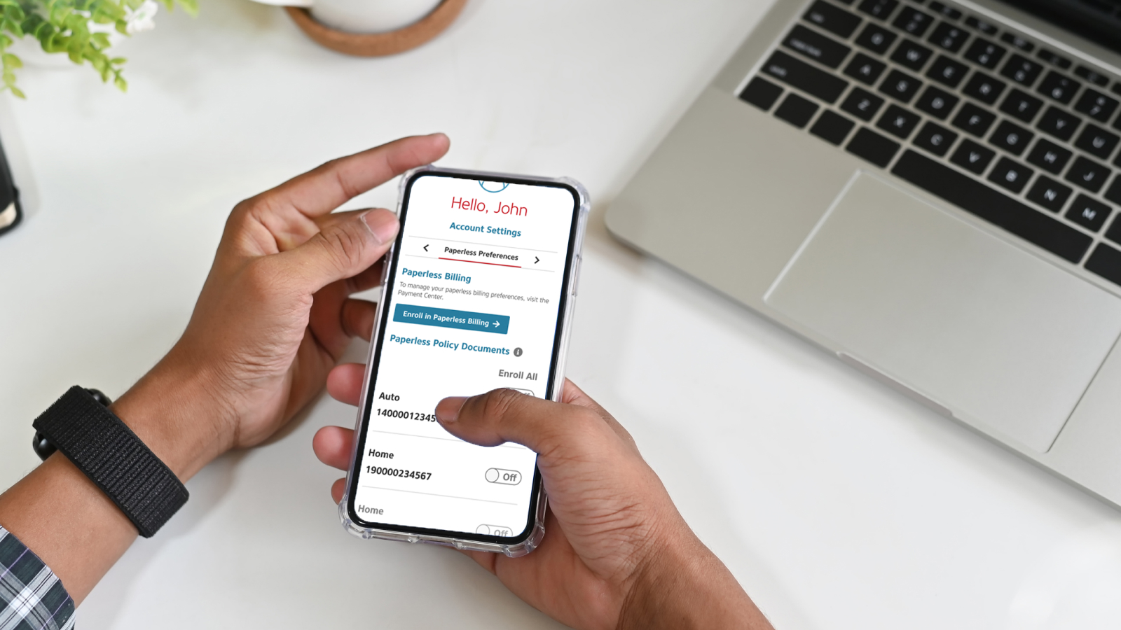 Hand holding a smartphone showing MyAlfa® insurance mobile app while enrolling in paperless policy documents.